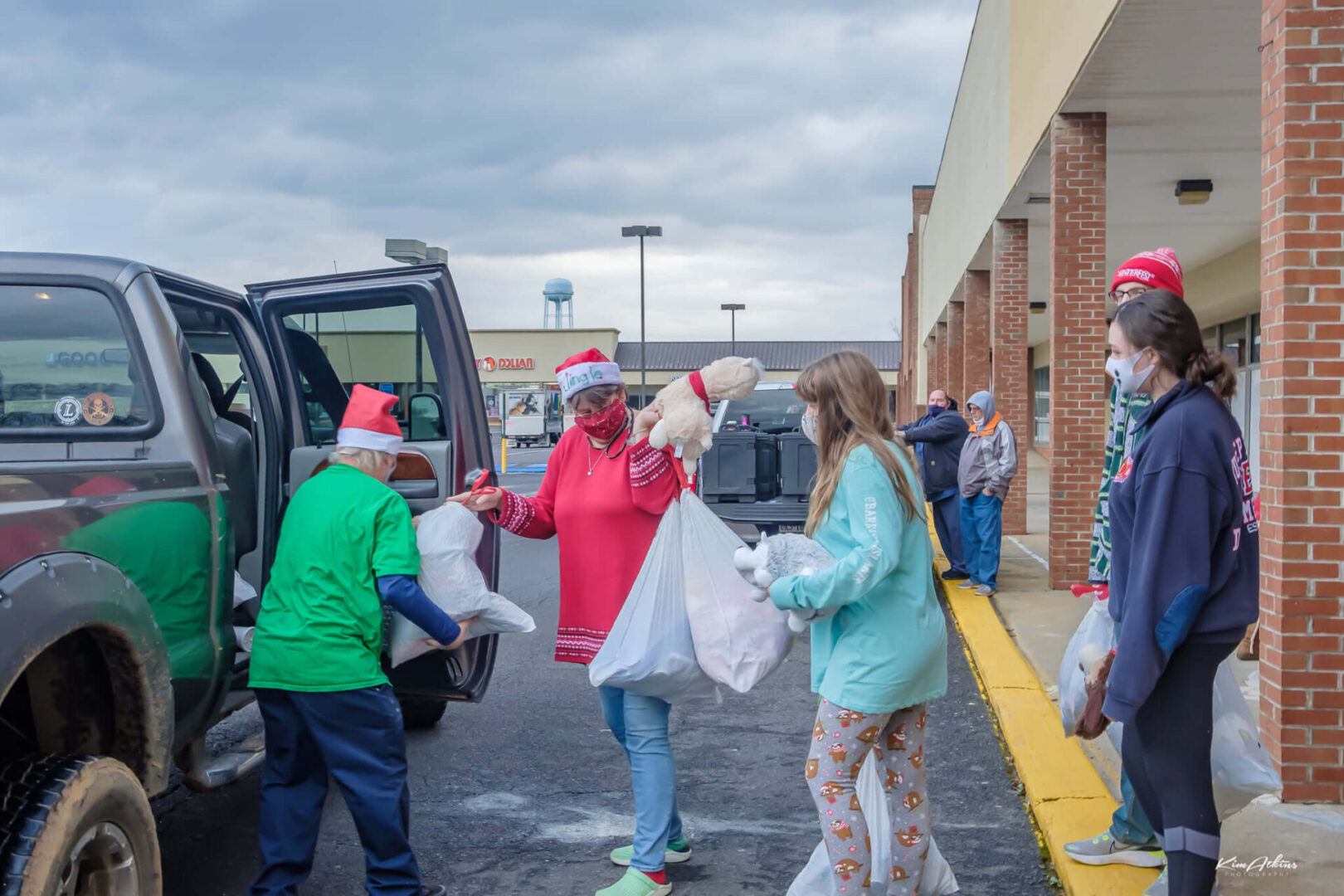 Group of people placing there shopping bags in the car